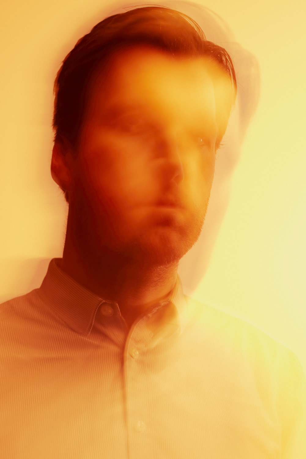 Abstract portrait of a man in yellow gloomy light. 