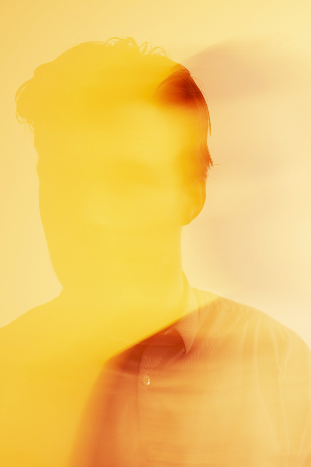 Abstract portrait of a man in yellow gloomy light. 
