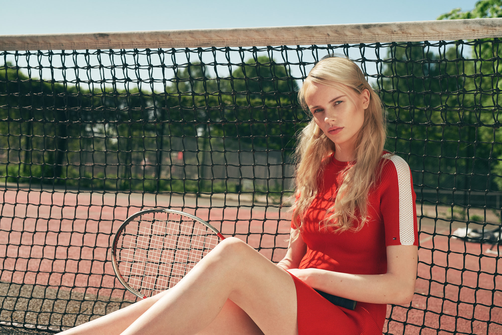 Tennis player leaning on the net. Editorial fashion series for Bogstadveien Magazine in Oslo by Håvard Schei.