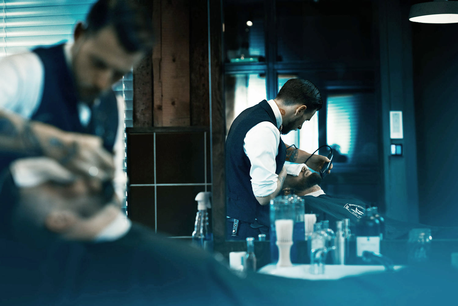 A portrait of a barber, from a cinematic story about the barber. Shot at Pels Pels in Oslo. 